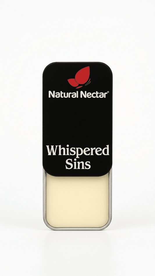 Natural Nectar Whispered Sins Patchouli Floral Solid Perfume tin in lifestyle shot with floral styling.