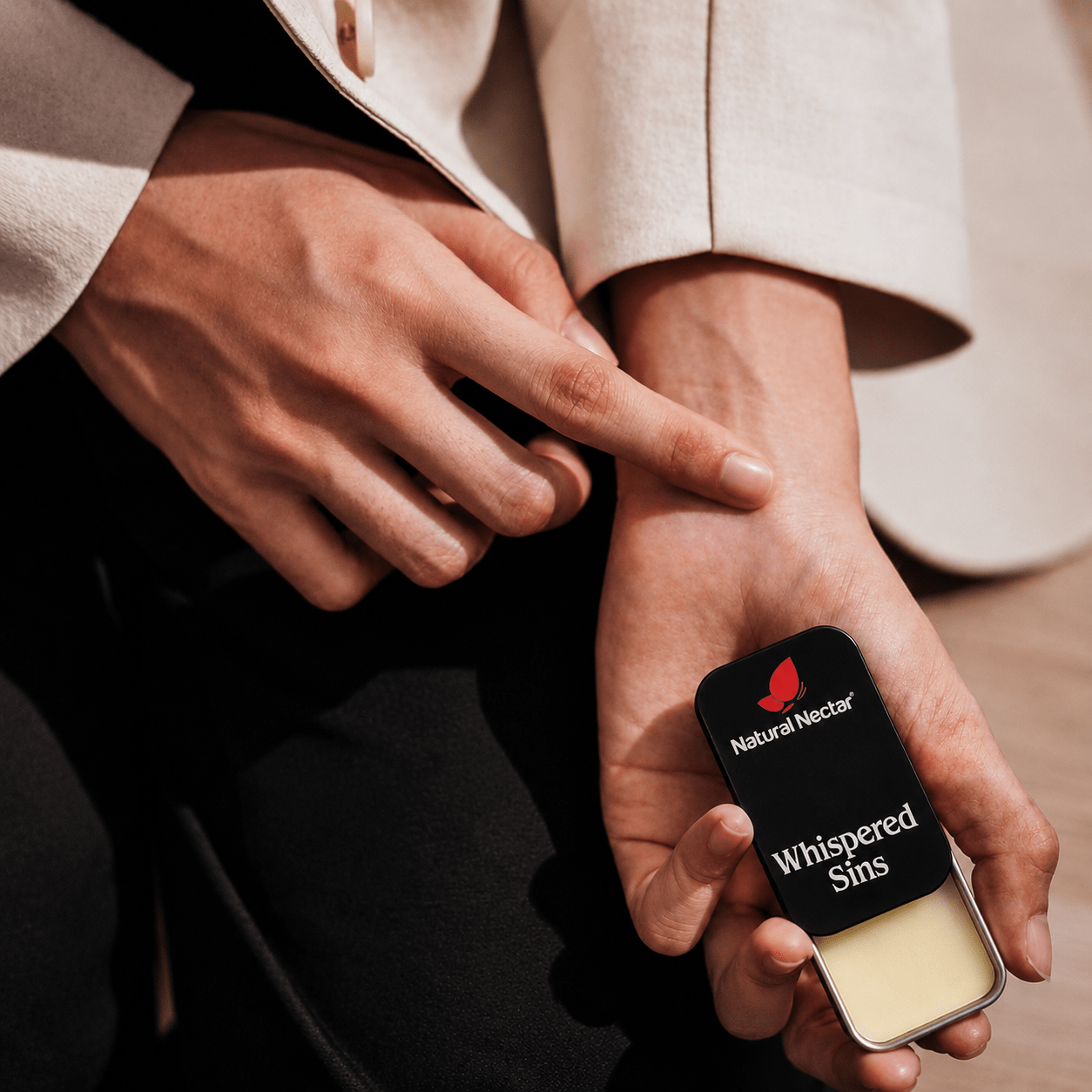 Natural Nectar Whispered Sins Patchouli Floral Solid Perfume flat-lay on neutral surface.