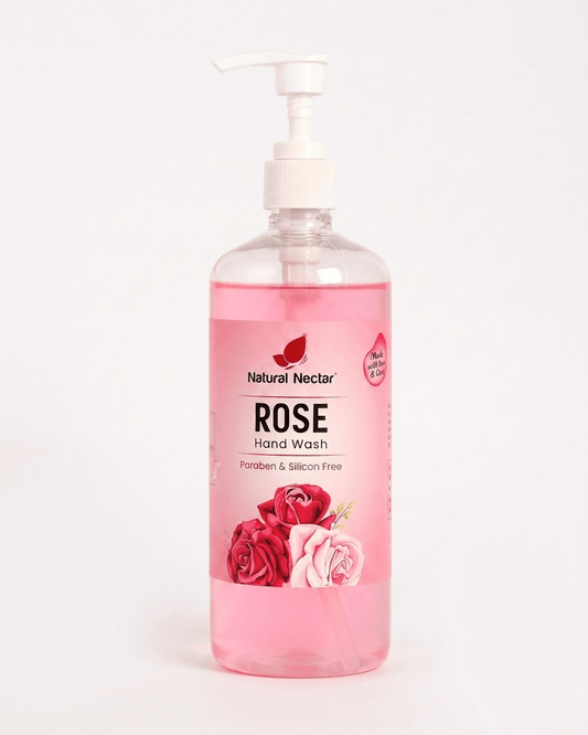 Natural Nectar Rose Hand Wash in a clear plastic pump bottle with pink liquid visible inside on a pale background.
